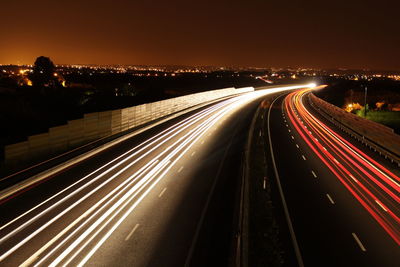 High angle view of light trails on highway at night