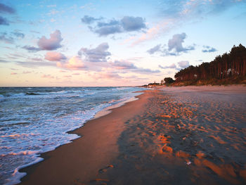 Scenic view of beach against sky during sunset