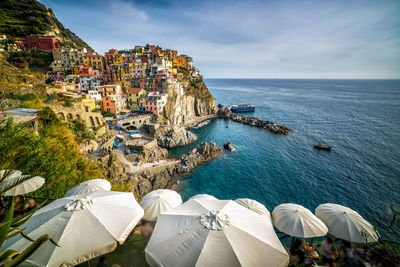 High angle view of buildings by sea against sky