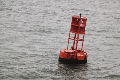 Close-up of red floating on sea