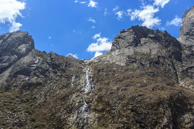 Low angle view of rock formations against sky