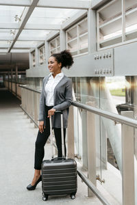 Full length of businesswoman standing on bridge