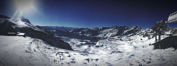 Scenic view of snowcapped mountains against clear sky