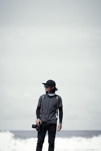 Man looking at sea against sky