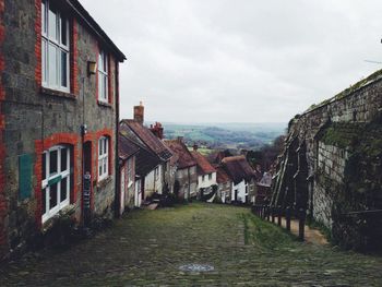 Buildings against cloudy sky