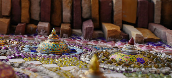 Close-up of multi colored candles in temple