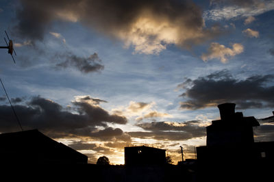 Low angle view of silhouette buildings against sky during sunset