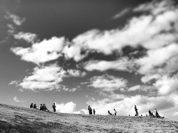 Silhouette of woman against cloudy sky