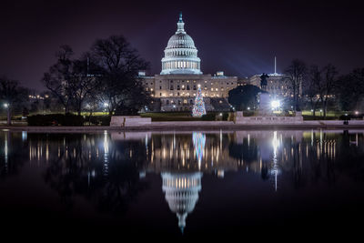 Reflection of united state capitol in water at night