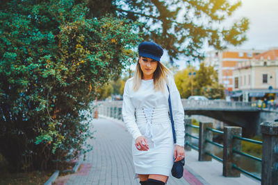 Portrait of woman walking on footbridge