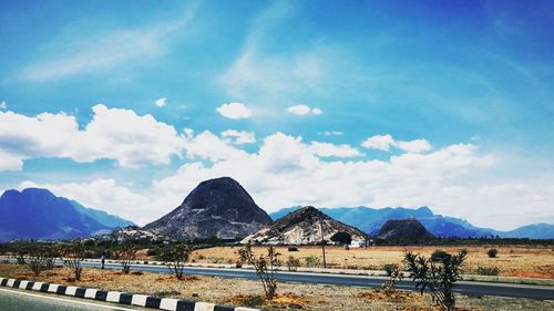 Scenic view of beach against cloudy sky