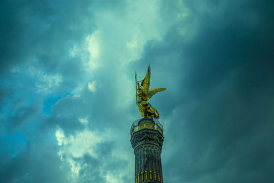 Low angle view of victory column against cloudy sky