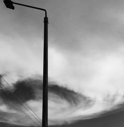 Low angle view of street light against cloudy sky