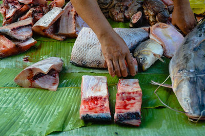 Close-up of hand holding fish at market