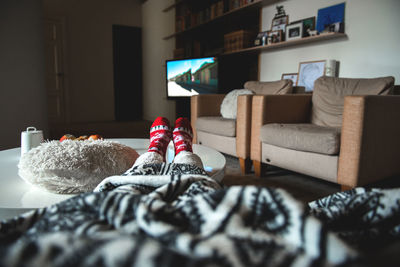 Low section of person watching tv at home