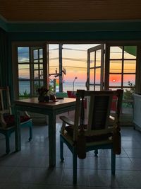 Chairs and tables in restaurant at sunset