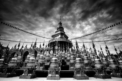View of temple and building against sky