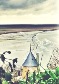 Scenic view of sea against cloudy sky