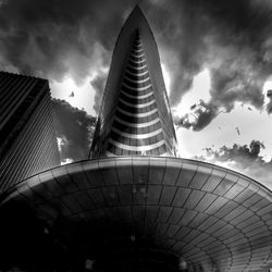 Low angle view of eiffel tower against cloudy sky