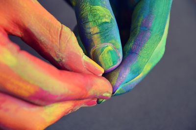Cropped hand of person with colorful powder paint