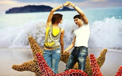 Couple standing at beach against sky