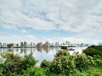 View of calm river with cityscape in background