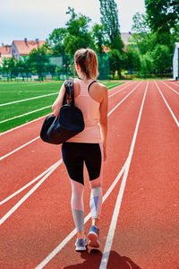 Woman going on fitness training with sport bag