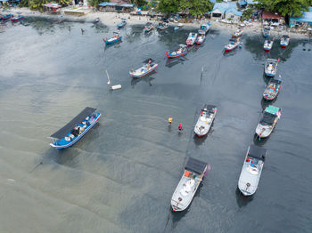 High angle view of boats moored on road by sea