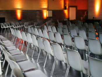 Empty chairs in illuminated seminar hall