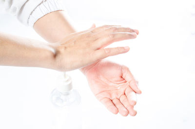 Close-up of woman hand over white background