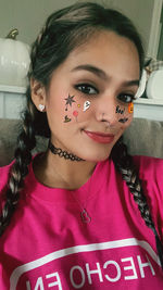 Close-up portrait of young woman at home