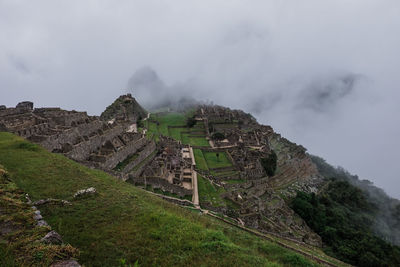 View towards machu picchu on a cloudy and rainy day