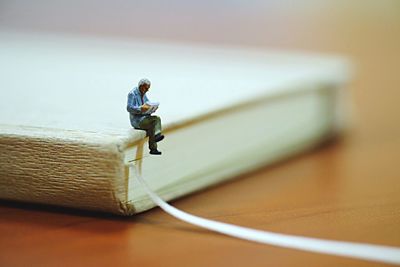 Close-up of figurine on book