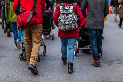 Low section of people walking on street