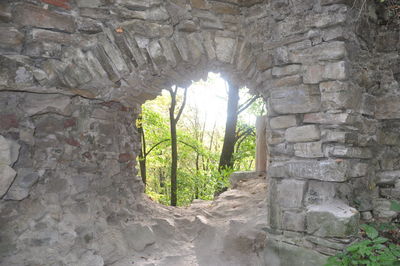 Arch window in old stone wall