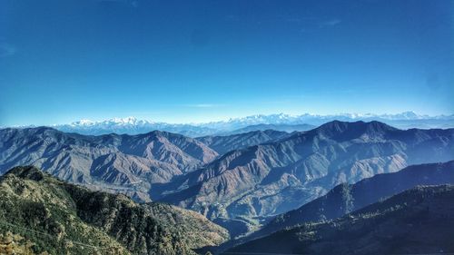 Scenic view of mountains against clear blue sky