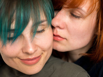 Close-up of lesbian couple romancing at home