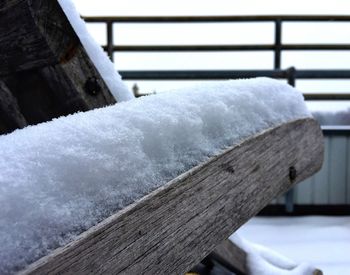 Close-up of snow covered wooden bench