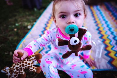 Portrait of cute boy holding toy