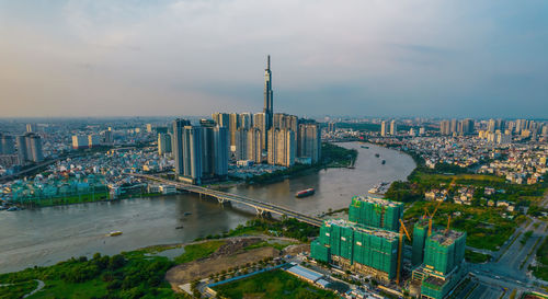 High angle view of modern buildings against cloudy sky