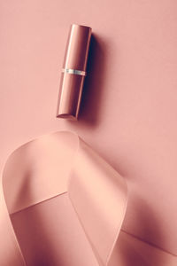 Close-up of beauty products on pink background