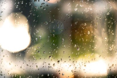 Full frame shot of raindrops on glass window