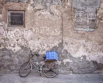 Bicycle parked against old wall