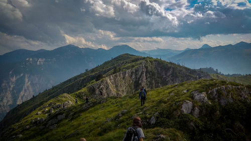 Rear view of man on mountain against sky