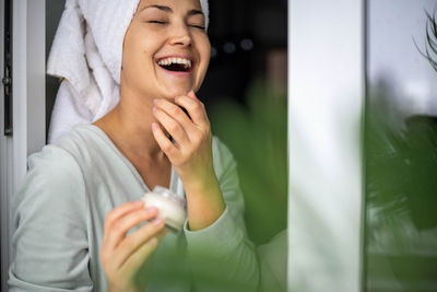 Portrait of young woman using mobile phone