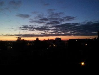 Silhouette cityscape against sky during sunset