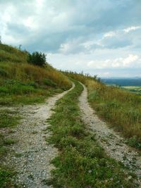 Empty road along countryside landscape