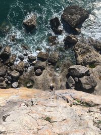 Directly above shot of young man climbing rock formation