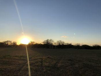 Scenic view of field against sky during sunset