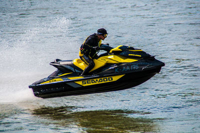 Man on yellow boat in river